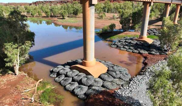 road rail bridge with Rock Bags on pylons
