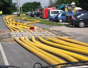 HYTRANS hoses deployed on a road using a hose ramp