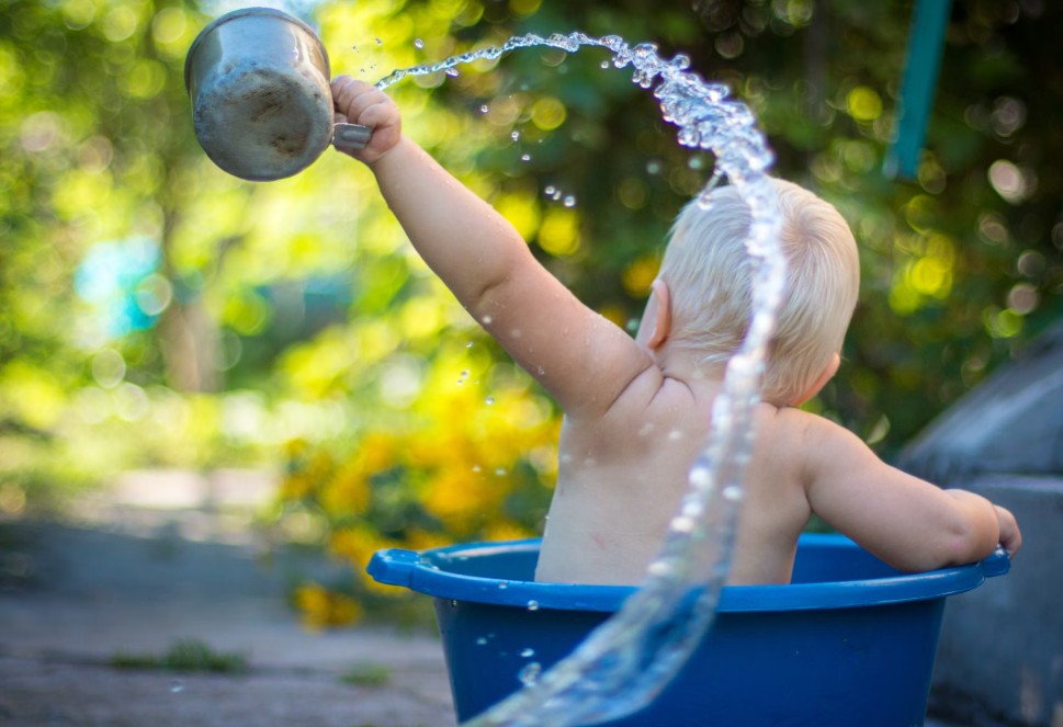 baby in water enjoying fresh water