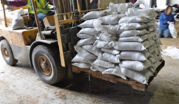 forklift carrying heavy sandbags